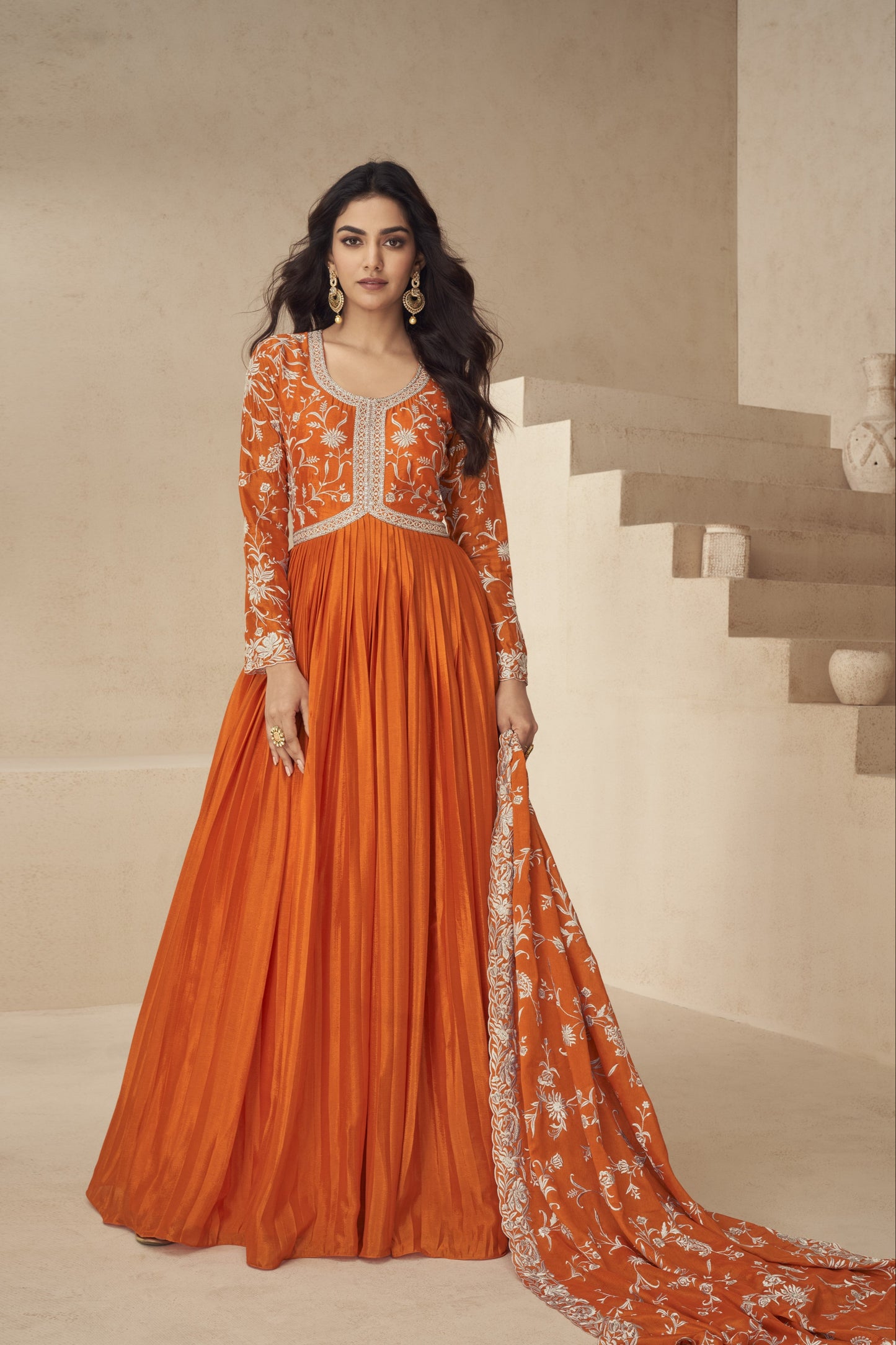 Bright orange gown with a festive flair, ideal for haldi ceremonies, daytime events, and cultural celebrations.
