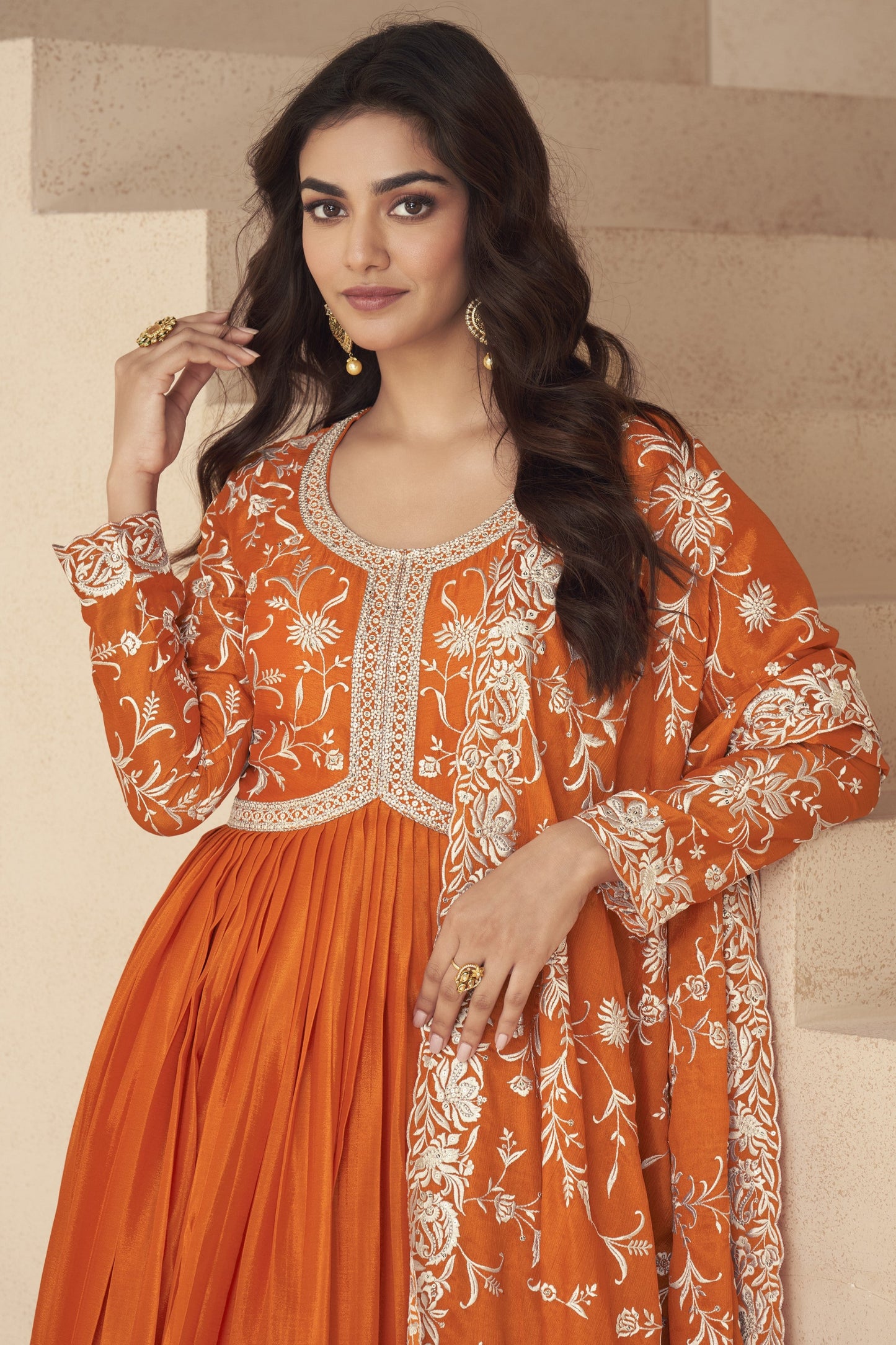 Bright orange gown with a festive flair, ideal for haldi ceremonies, daytime events, and cultural celebrations.