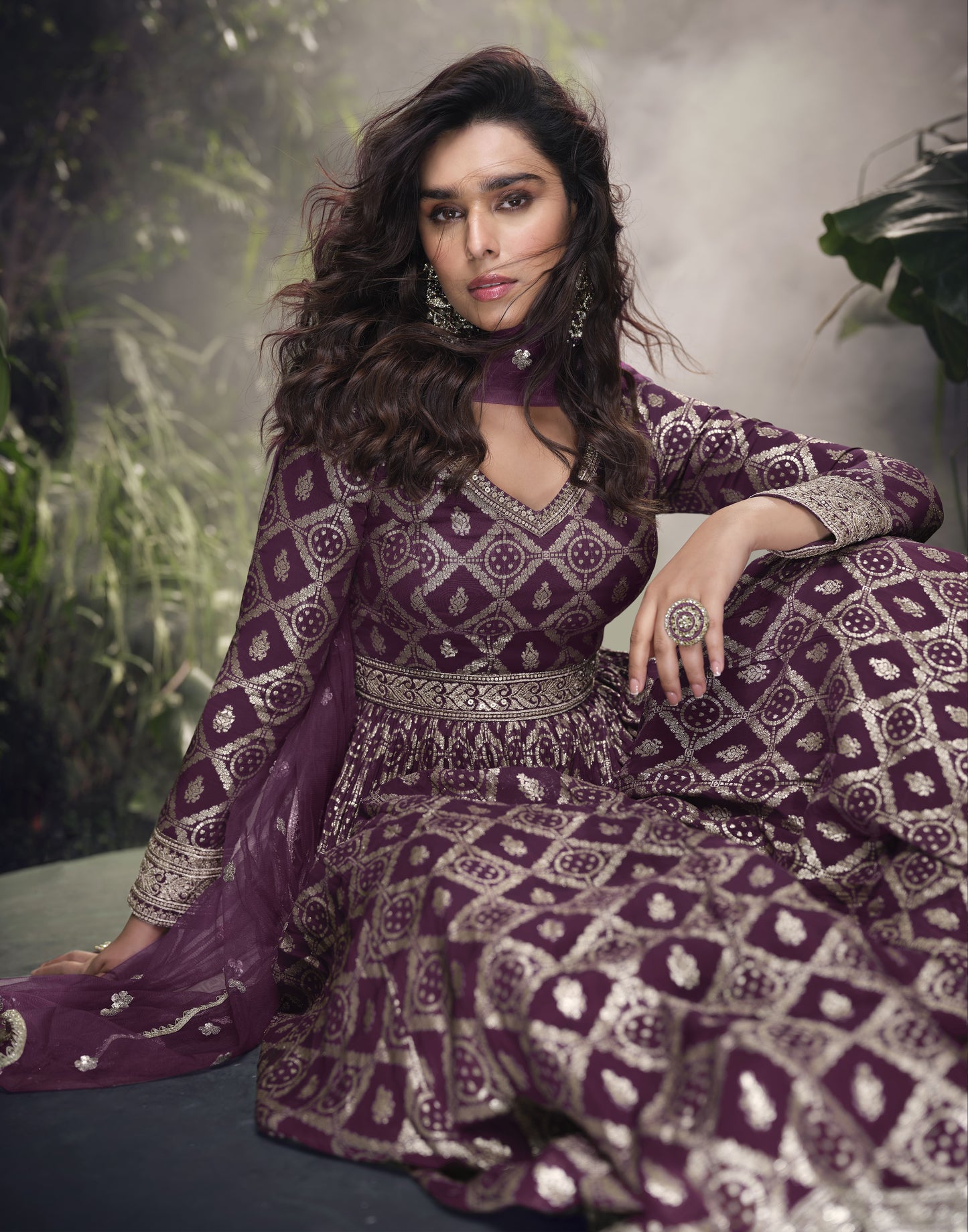 Dark purple Anarkali gown in viscose jacquard silk with embroidery work, complemented by a net dupatta for a rich and graceful festive look.