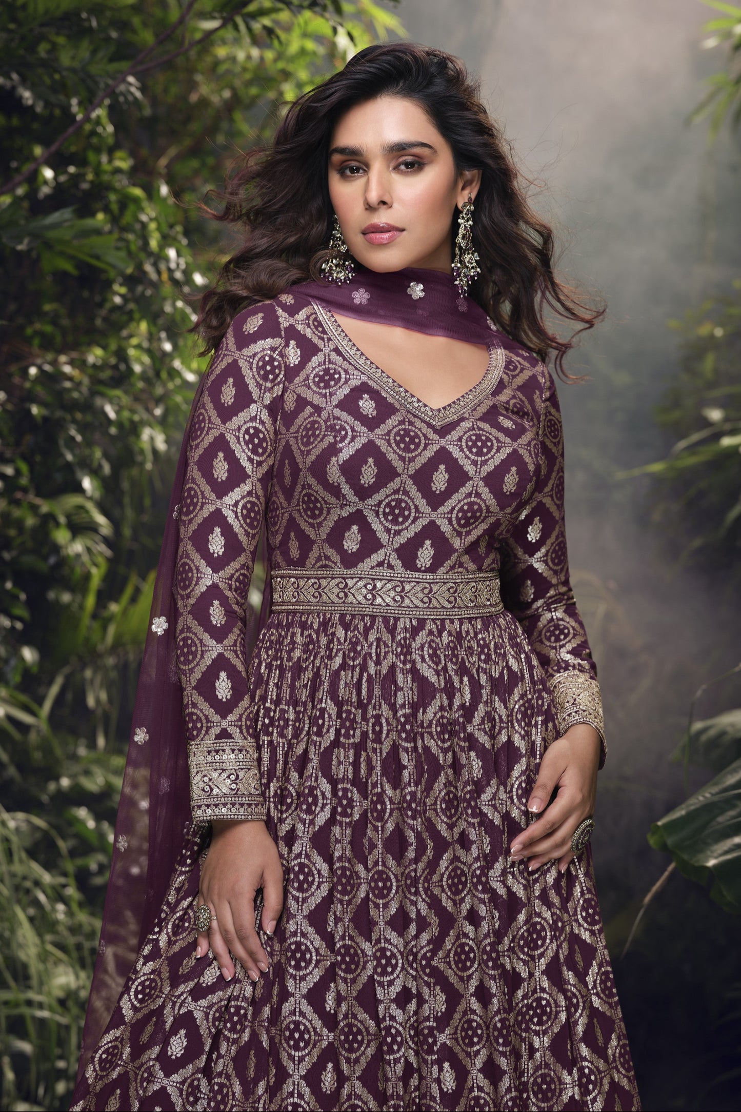 Dark purple Anarkali gown in viscose jacquard silk with embroidery work, complemented by a net dupatta for a rich and graceful festive look.