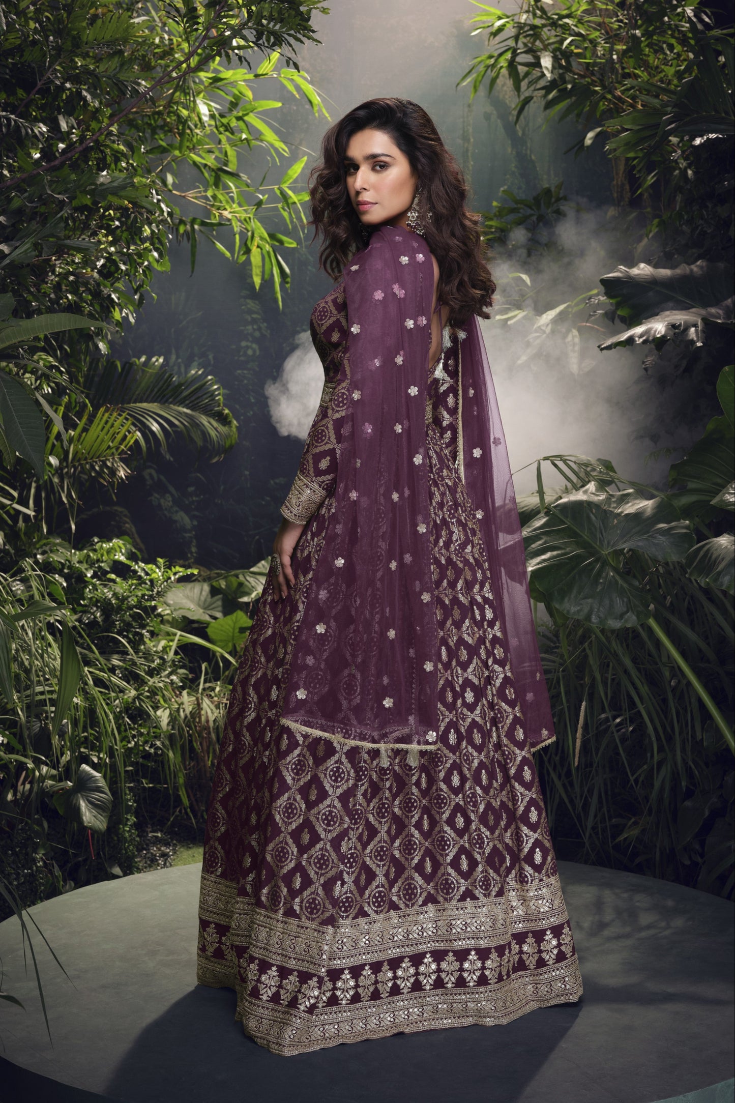 Dark purple Anarkali gown in viscose jacquard silk with embroidery work, complemented by a net dupatta for a rich and graceful festive look.