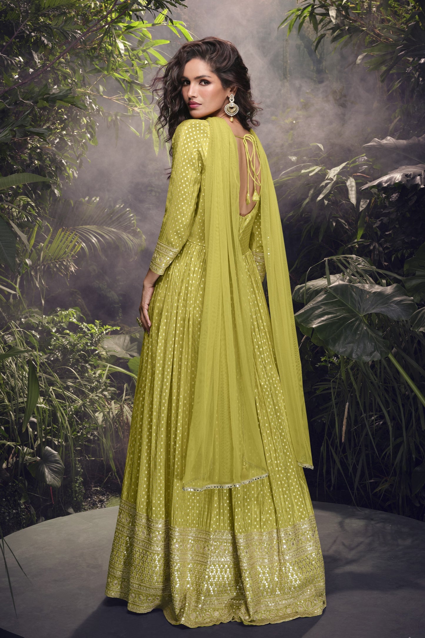 Yellow Anarkali gown in viscose jacquard silk with embroidery work, paired with a net dupatta to create a bright and elegant festive outfit.