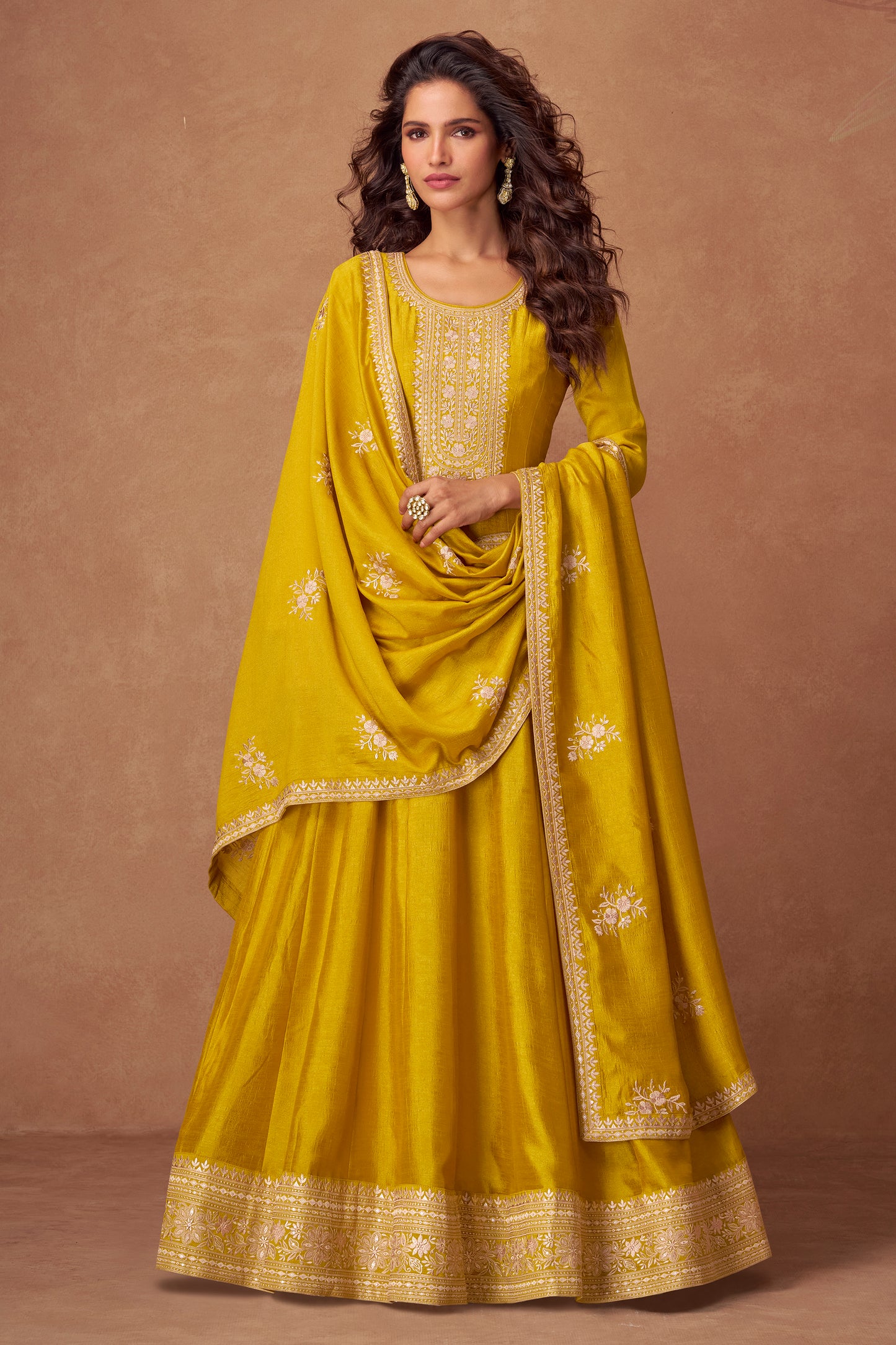 Yellow color Anarkali gown radiates warmth and charm, ideal for Haldi functions, daytime events, and festive occasions.