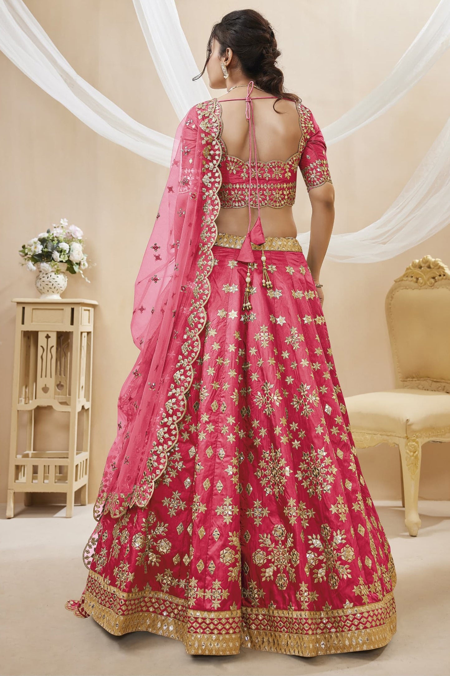 Pink bridal lehenga choli with embroidery for wedding reception.