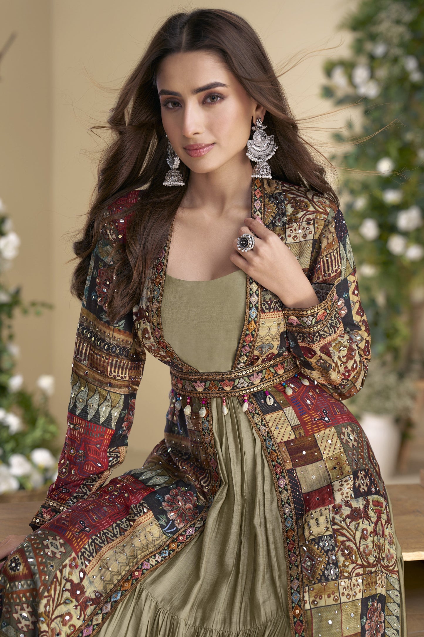 Sage green Indo-Western Anarkali gown in silk fabric with embellished work, offering a subtle yet stylish look for festive occasions.