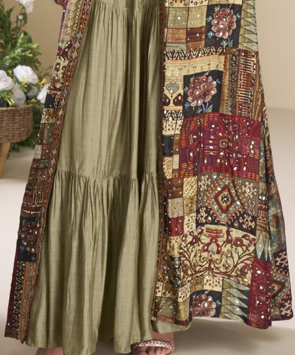 Sage green Indo-Western Anarkali gown in silk fabric with embellished work, offering a subtle yet stylish look for festive occasions.