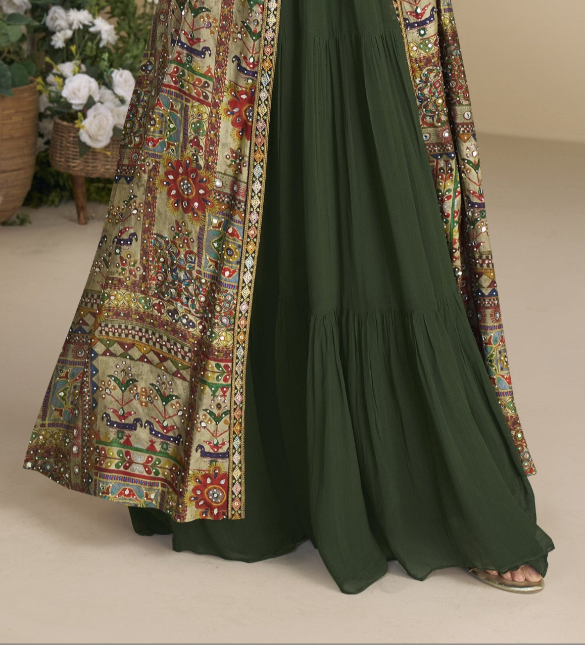 Dark green Indo-Western Anarkali gown in silk fabric with embellished work, showcasing a regal and graceful festive look.