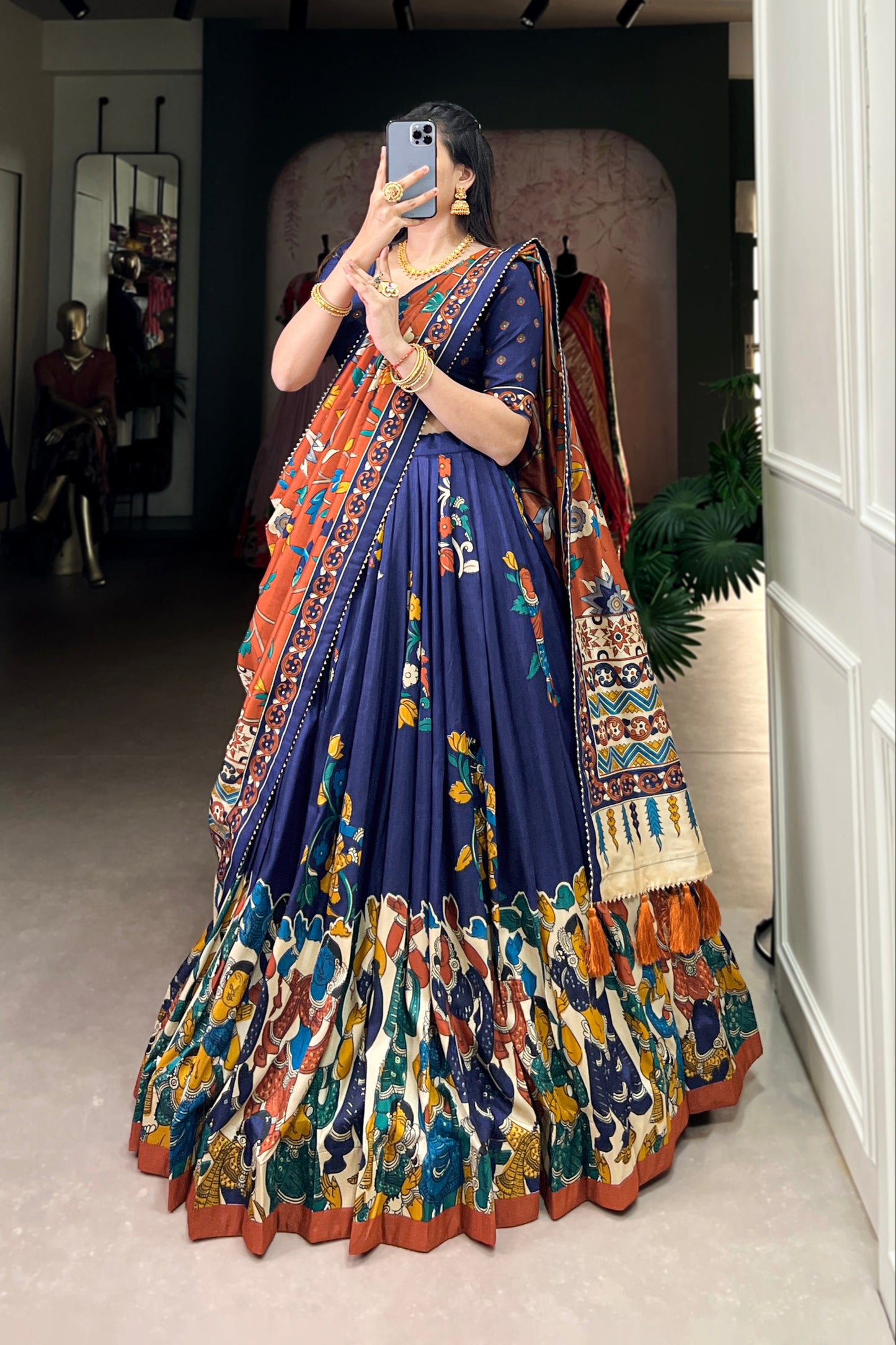 Navy blue Tussar silk lehenga with Kalamkari print work, blending traditional art with elegant festive style.