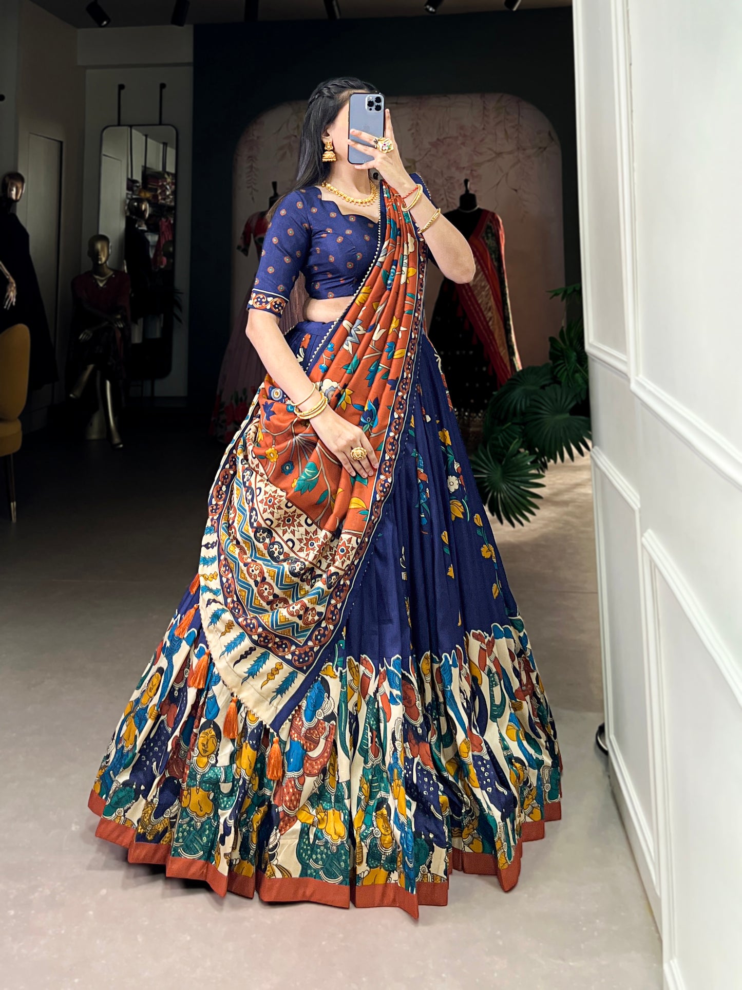 Navy blue Tussar silk lehenga with Kalamkari print work, blending traditional art with elegant festive style.