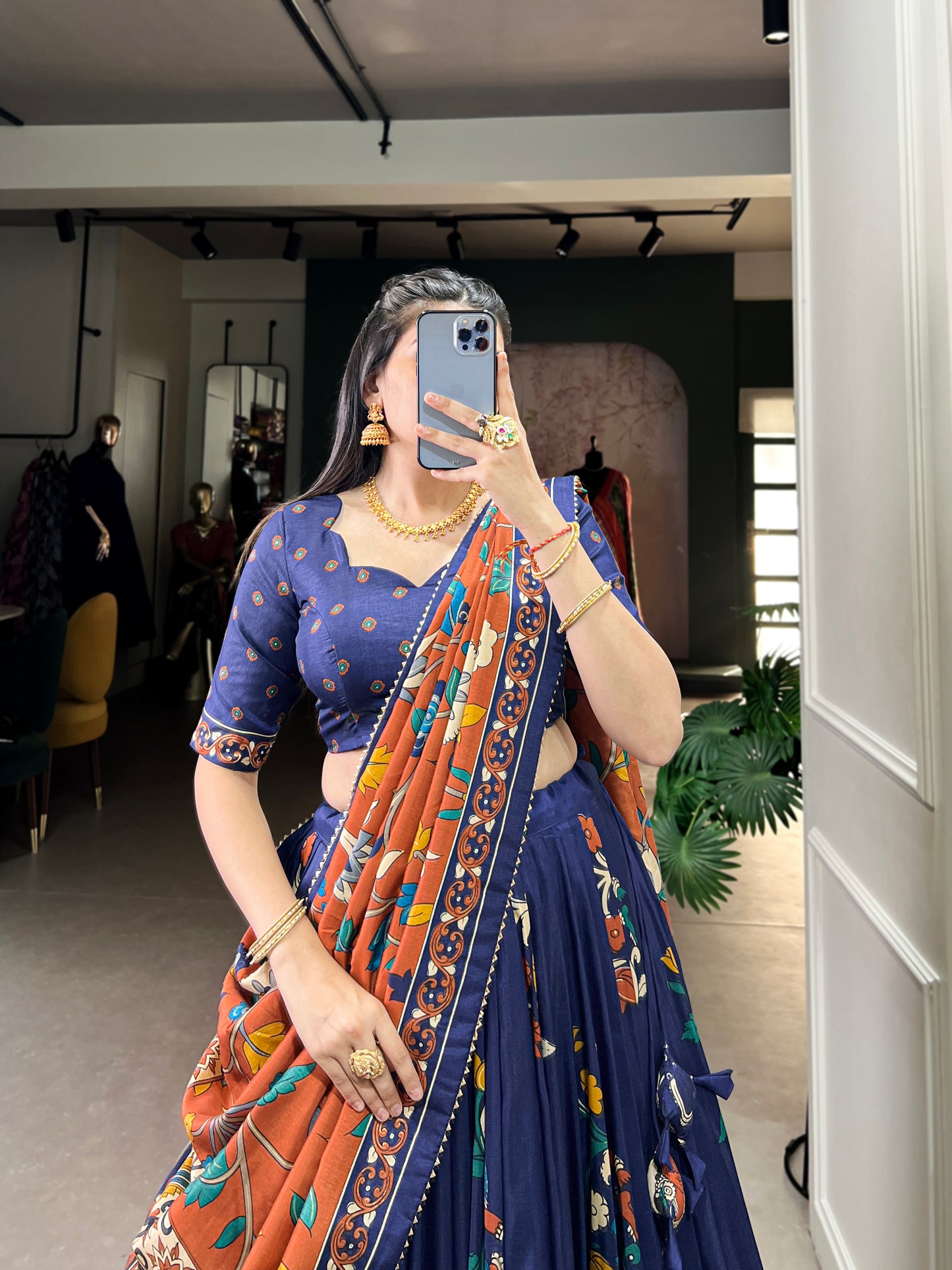 Navy blue Tussar silk lehenga with Kalamkari print work, blending traditional art with elegant festive style.