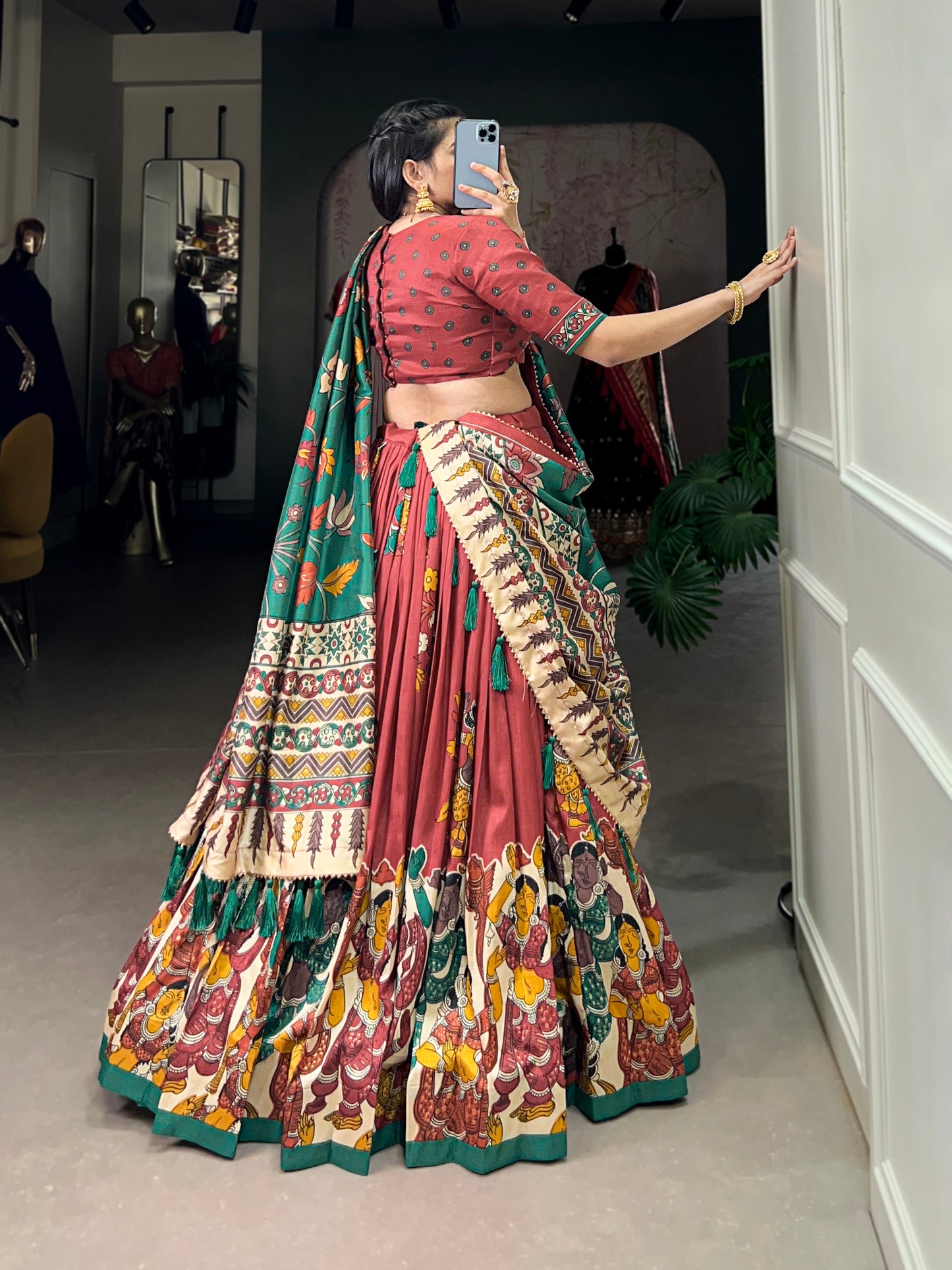 Red Tussar silk lehenga with Kalamkari print work, adorned with vibrant traditional motifs for a bold and festive look.