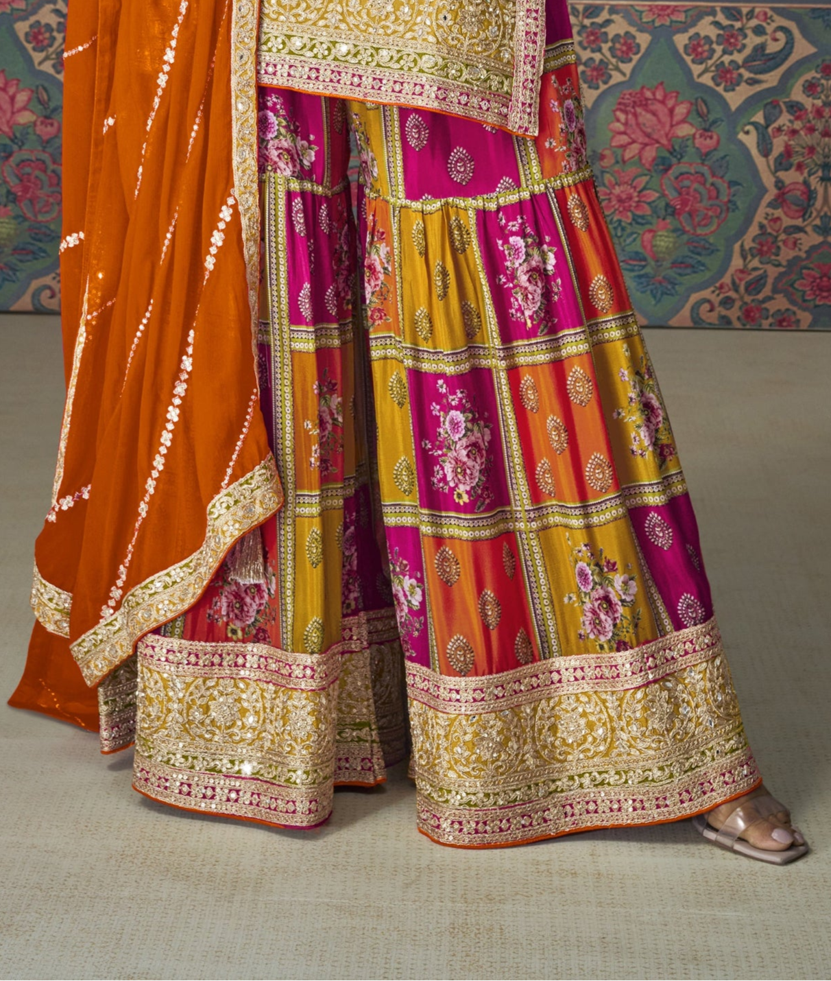 Pink color palazzo suit with embroidery work, paired with an orange dupatta, creating a vibrant and contrasting look perfect for festive and traditional occasions.
