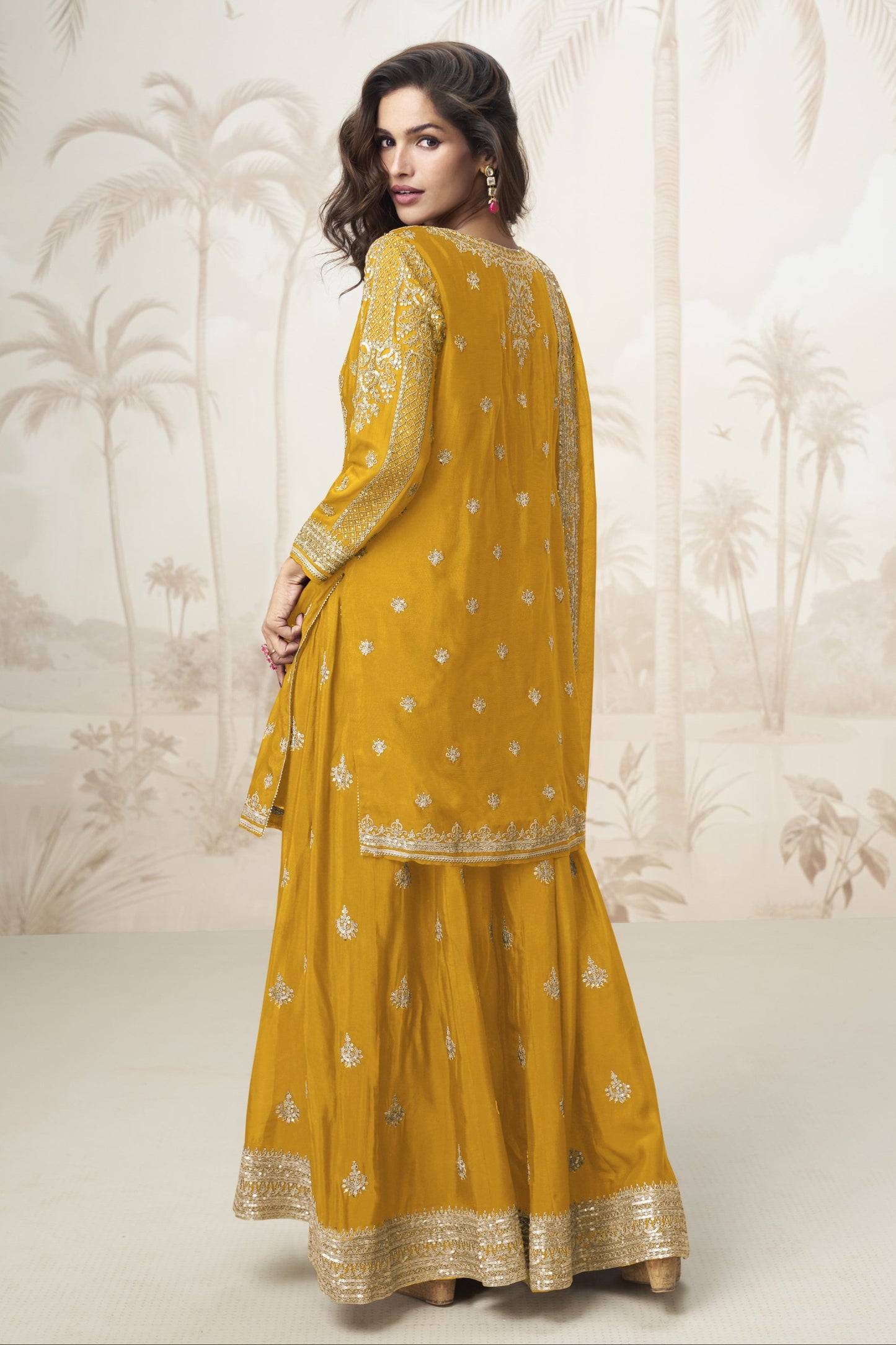 Yellow color palazzo suit with embroidery work, radiating cheerful elegance and festive charm, perfect for traditional occasions and celebrations.