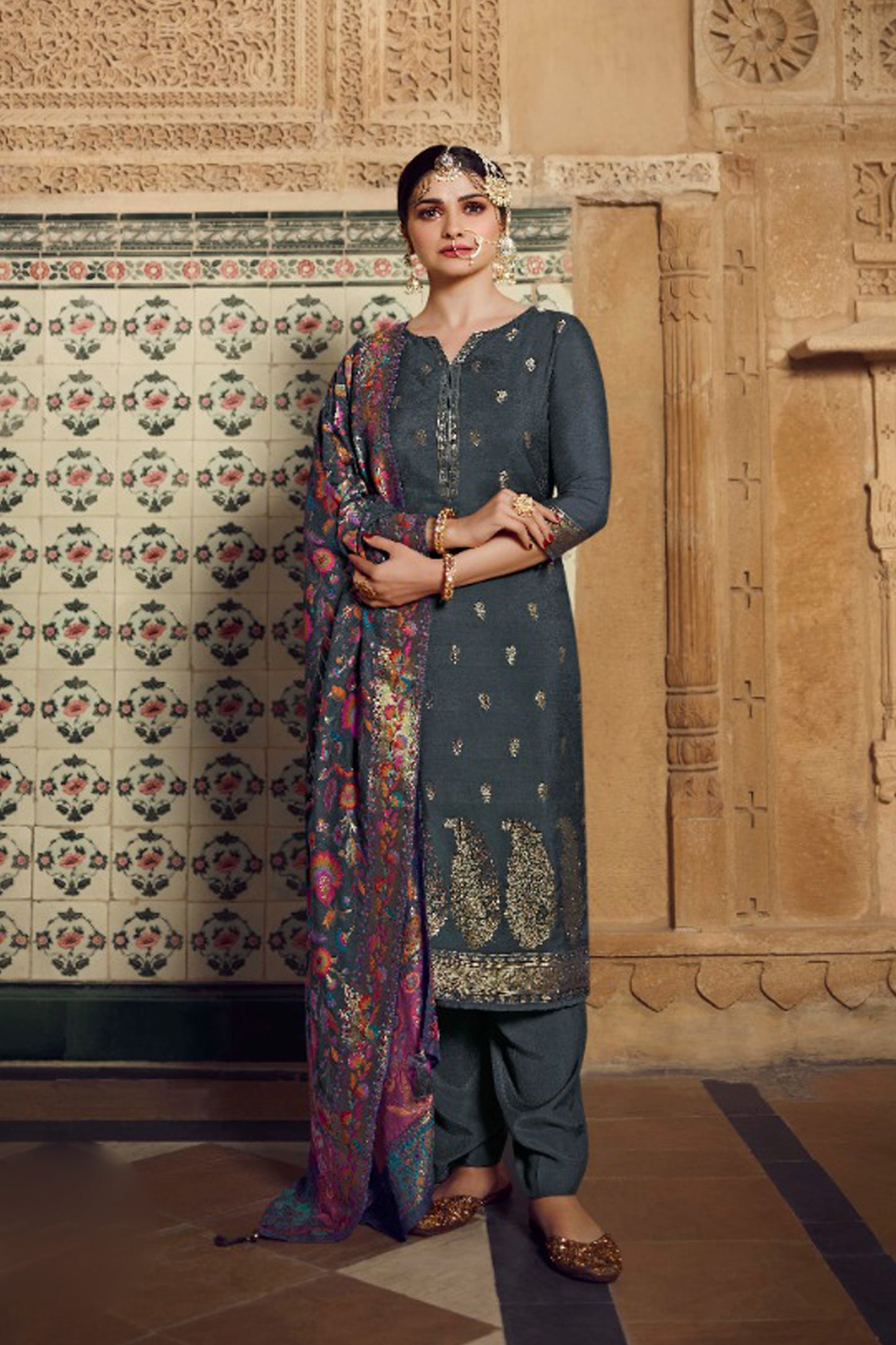 Grey salwar kameez looks simple and stylish. Metallic accents make it modern.
