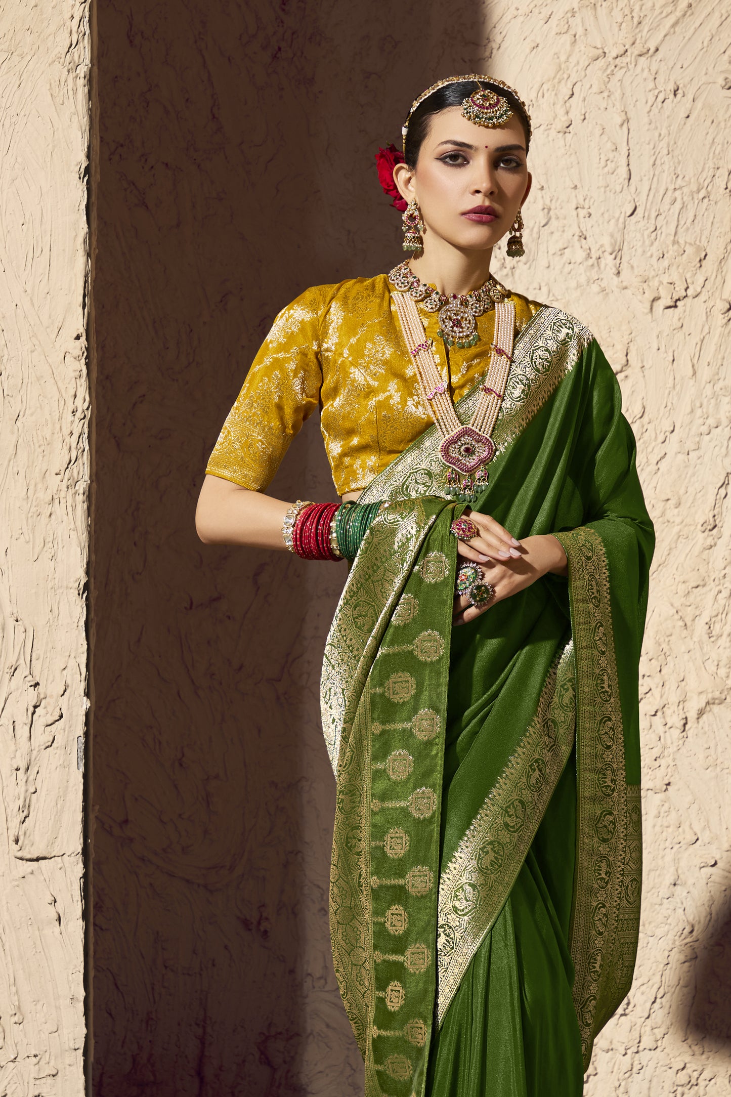 Beautiful ethnic fashion portrait of lady dressed in green Banarasi saree, traditional Indian bridal jewellery set, red roses bun hairstyle, luxury festive wear