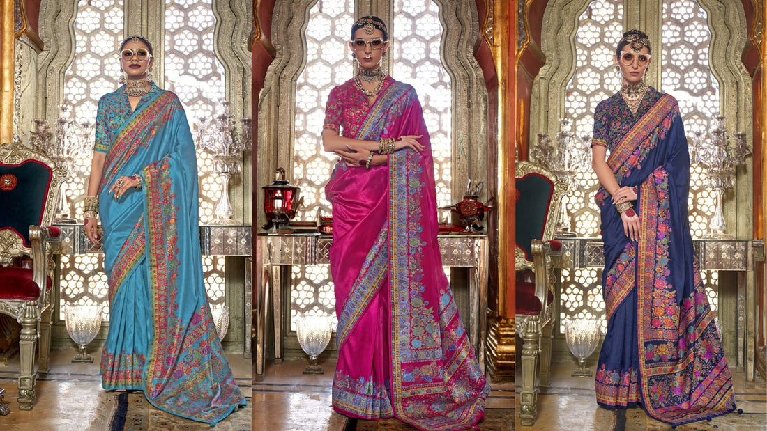 Three regal heritage silk sarees in turquoise, pink, and navy blue with intricate multicolor embroidery and traditional zari borders, modeled in a luxurious royal palace setting