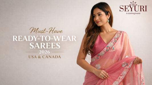 Woman wearing a pink saree with floral patterns, standing against a light gray background. Text promotes 'Must-Have Ready-to-Wear Sarees 2026' for USA & Canada by Seyyuri.