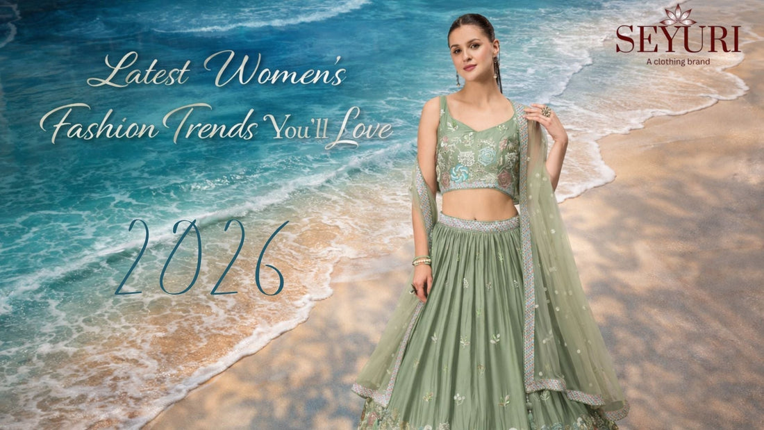 Woman wearing a sage green embroidered lehenga with matching dupatta, standing on a beach with turquoise ocean waves and sandy shore in the background, featuring the text “Latest Women’s Fashion Trends You’ll Love” centered for a fashion blog banner.