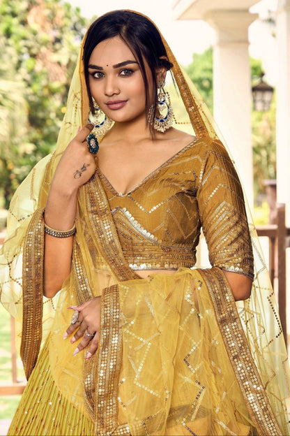 Bollywood Style Ochre Color Chinon Fabric Designer And Luxuru Lehenga With Net Dupatta