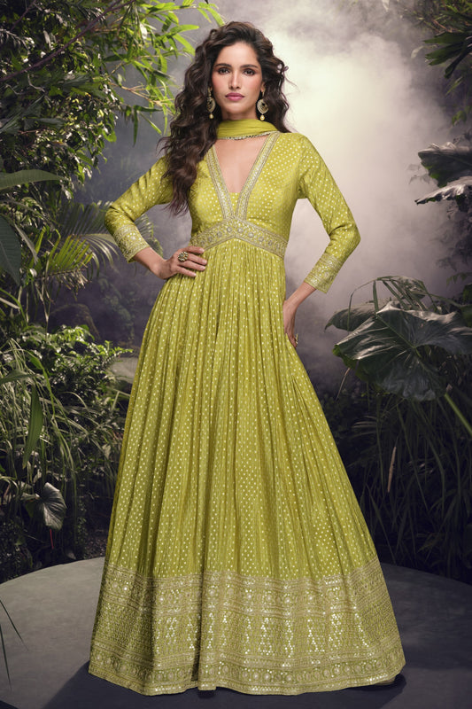 Yellow Anarkali gown in viscose jacquard silk with embroidery work, paired with a net dupatta to create a bright and elegant festive outfit.
