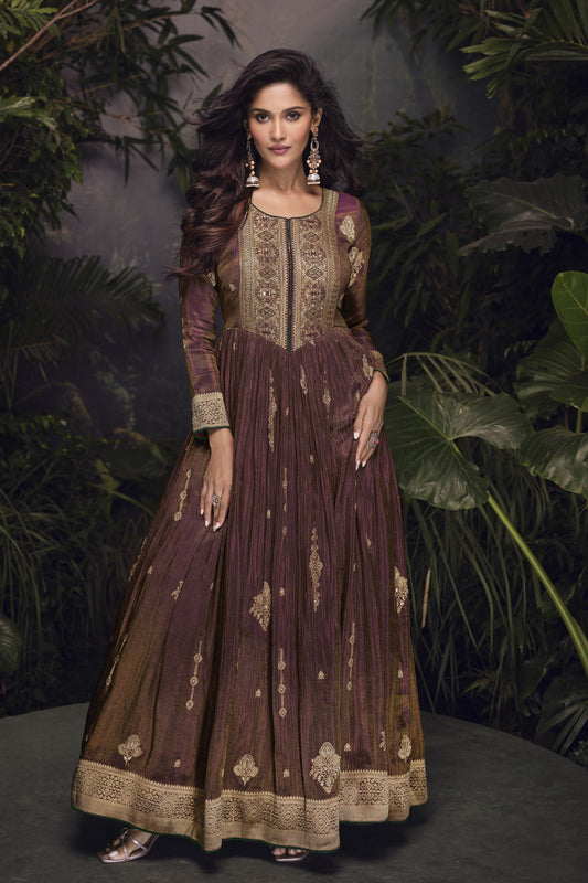 Dark brown Anarkali gown in viscose jacquard silk with embroidery work, paired with a net dupatta for an elegant festive ensemble.
