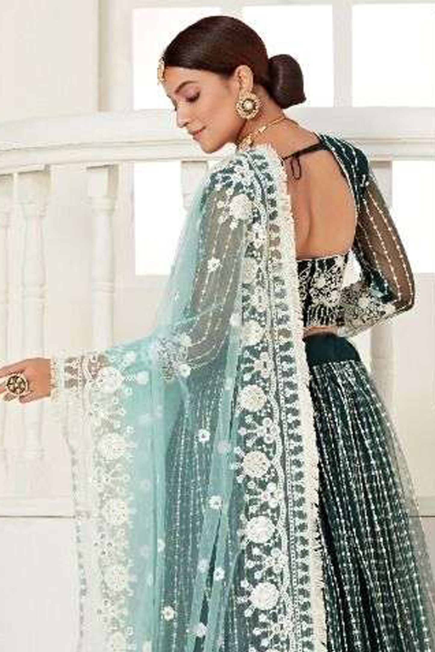 Close-Up Embroidery Detail On Green Bridal Lehenga Choli With Heavy Net Fabric