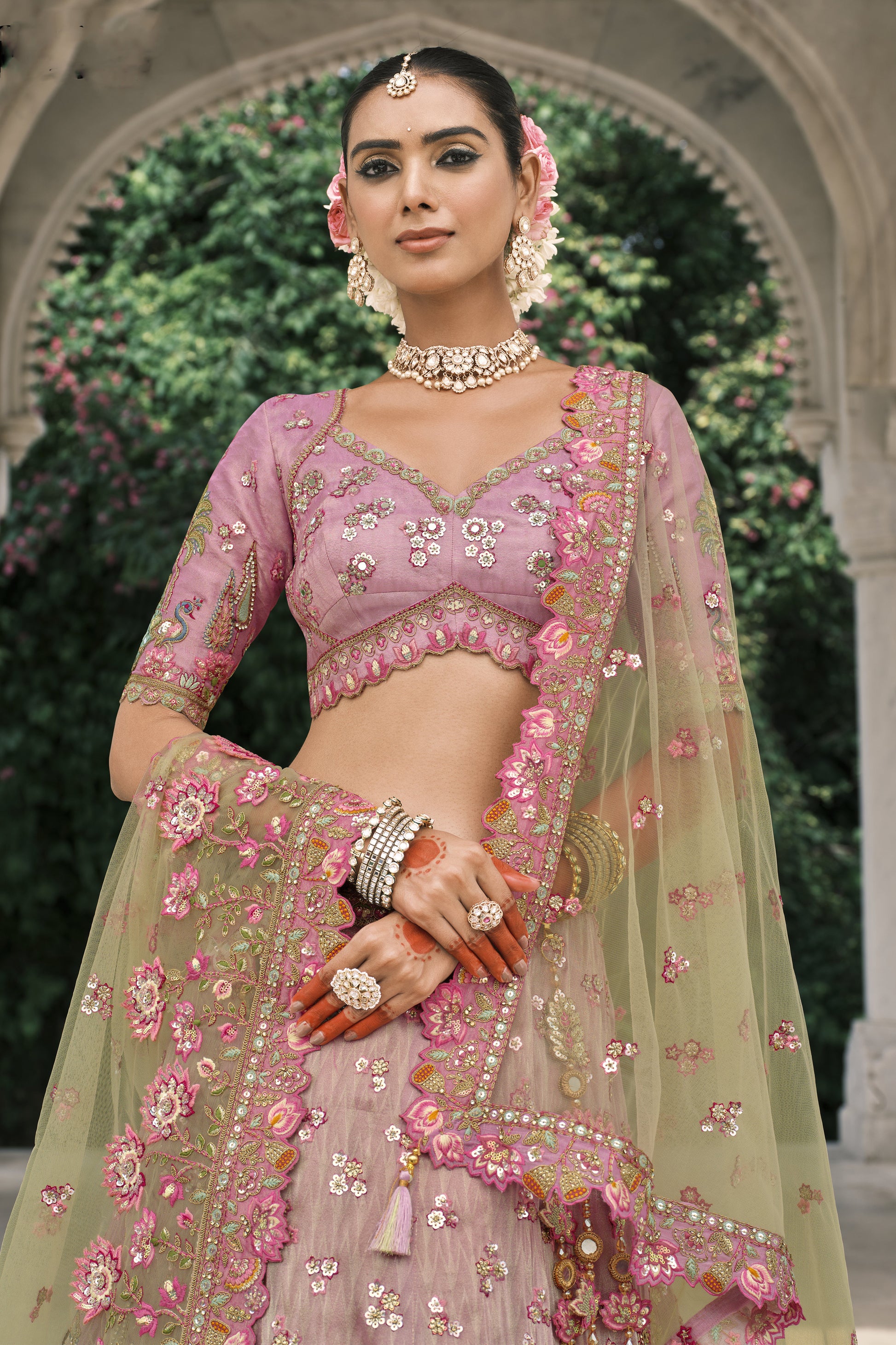 Pastel pink embroidered choli with floral handwork, sequins, and matching net dupatta detailing