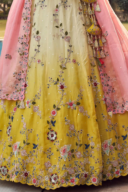 A Stylish Ethnic look featuring a yellow Embroidered Lehenga with Pink Dupatta captured in Daylight.