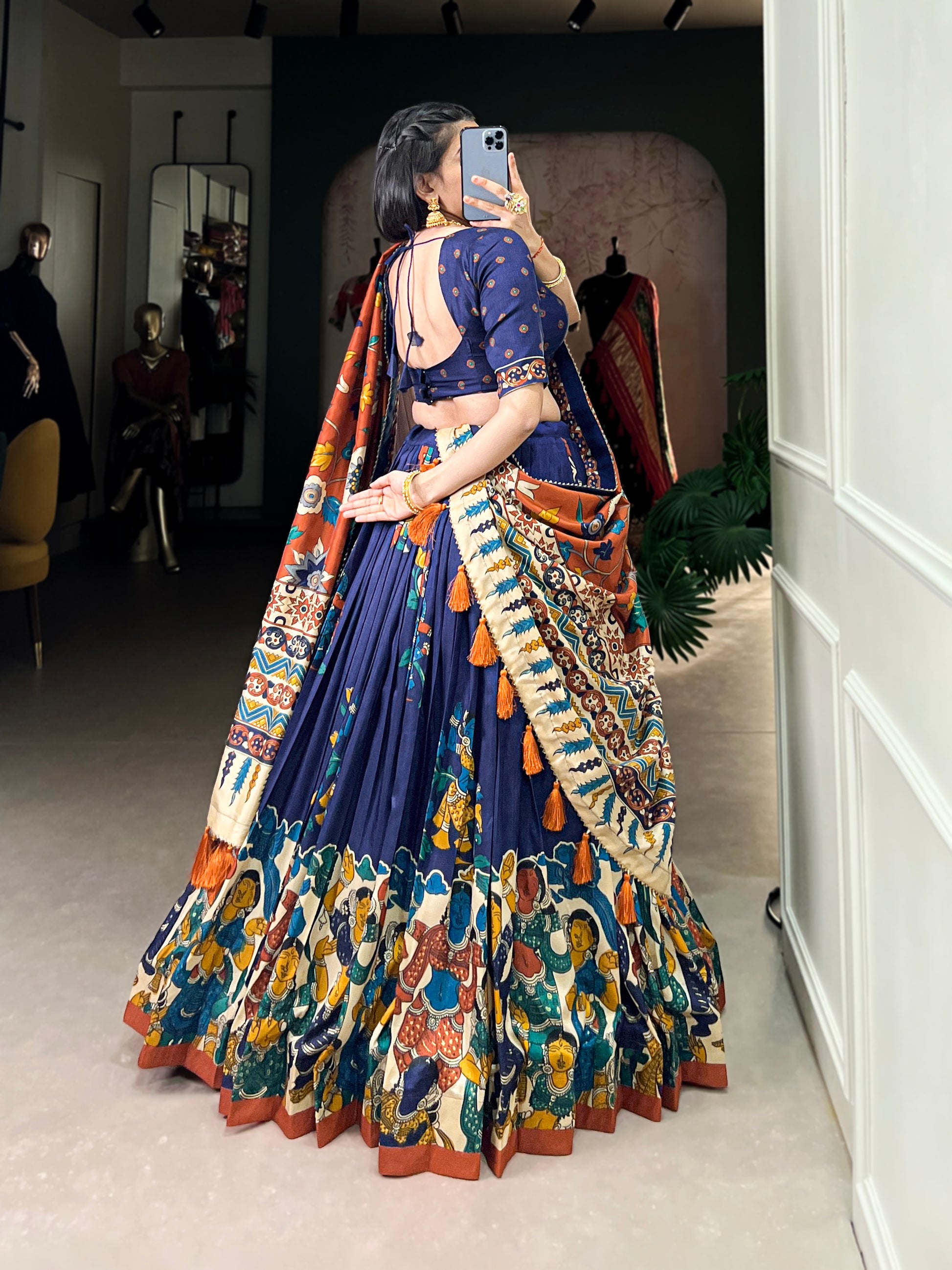 Navy blue Tussar silk lehenga with Kalamkari print work, blending traditional art with elegant festive style.
