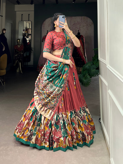 Red Tussar silk lehenga with Kalamkari print work, adorned with vibrant traditional motifs for a bold and festive look.
