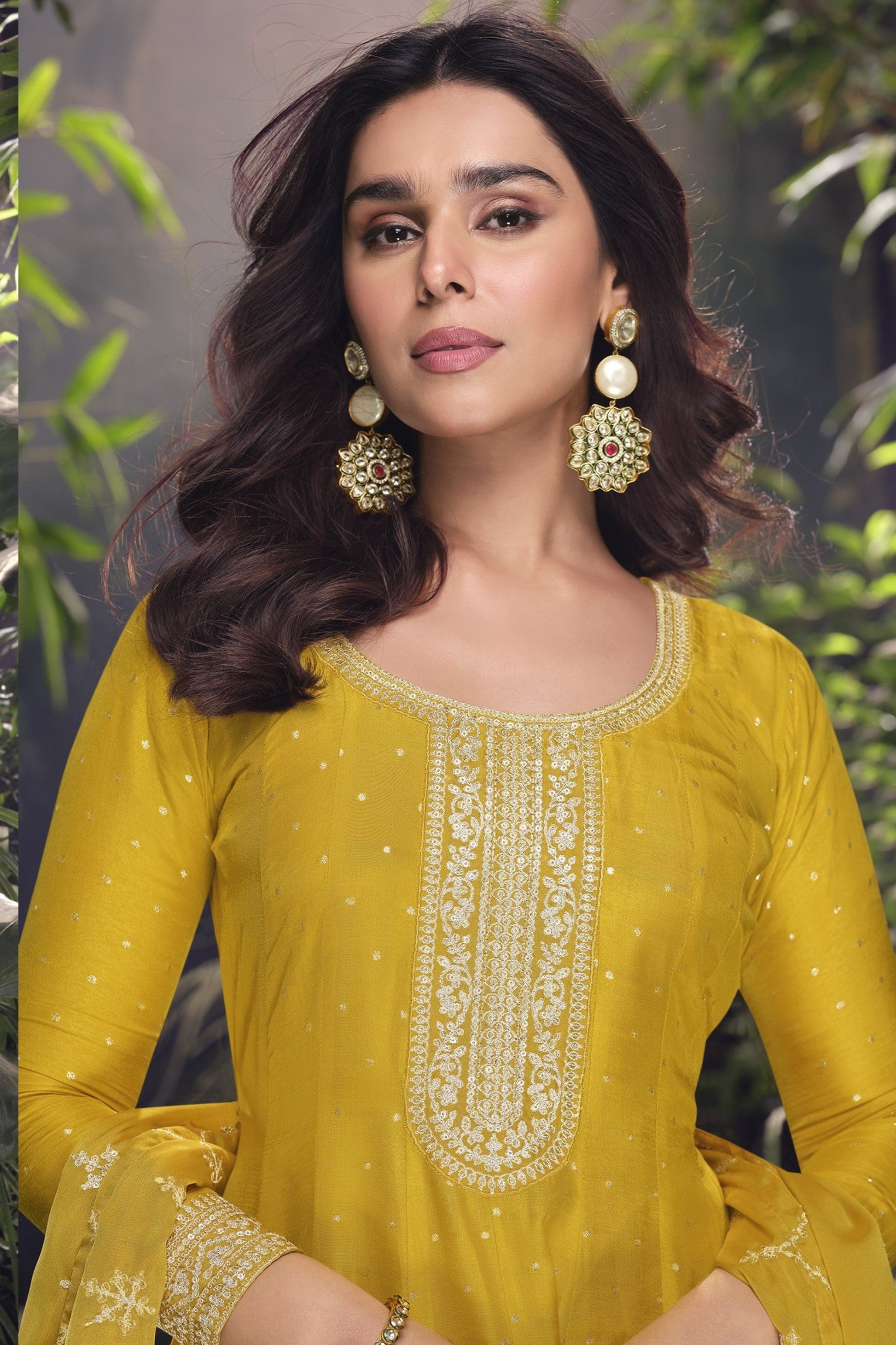 Yellow color Anarkali gown in pure viscose silk with embroidery work, combining brightness and elegance for a festive-ready look.
