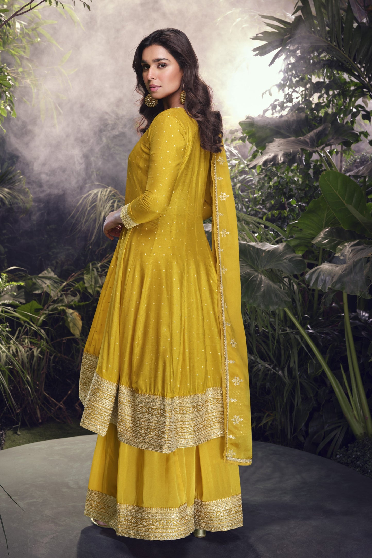 Yellow color Anarkali gown in pure viscose silk with embroidery work, combining brightness and elegance for a festive-ready look.
