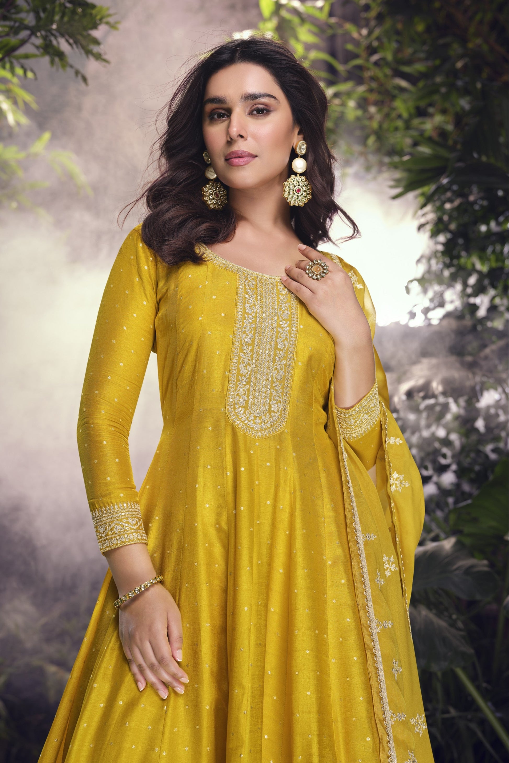 Yellow color Anarkali gown in pure viscose silk with embroidery work, combining brightness and elegance for a festive-ready look.
