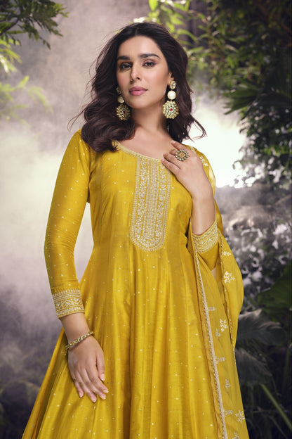 Yellow color Anarkali gown in pure viscose silk with embroidery work, combining brightness and elegance for a festive-ready look.
