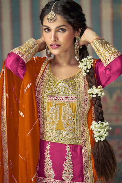 Pink color palazzo suit with embroidery work, paired with an orange dupatta, creating a vibrant and contrasting look perfect for festive and traditional occasions.
