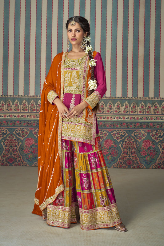 Pink color palazzo suit with embroidery work, paired with an orange dupatta, creating a vibrant and contrasting look perfect for festive and traditional occasions.
