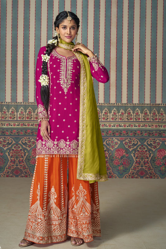 Pink color palazzo suit with embroidery work, paired with orange palazzo and a contrasting green dupatta, offering a vibrant and festive fusion perfect for traditional celebrations.
