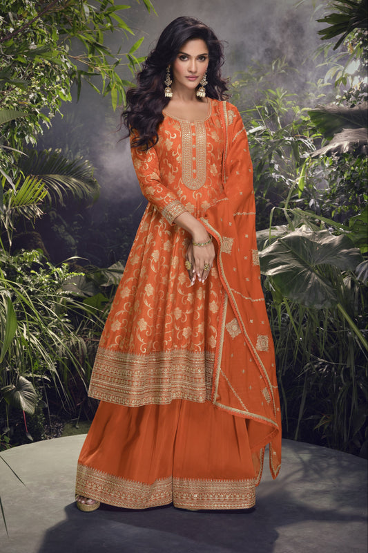 Orange color Anarkali gown in pure viscose silk with embroidery work, radiating vibrant charm perfect for festive and celebratory occasions.
