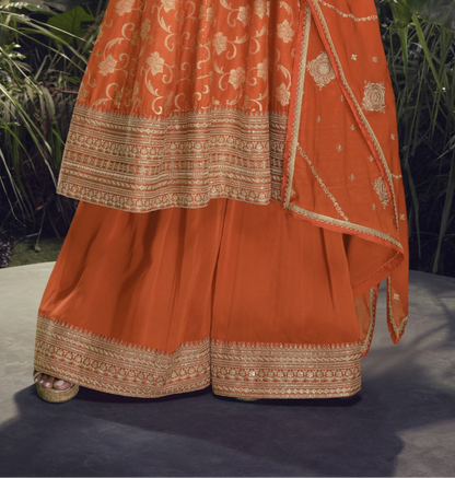 Orange color Anarkali gown in pure viscose silk with embroidery work, radiating vibrant charm perfect for festive and celebratory occasions.
