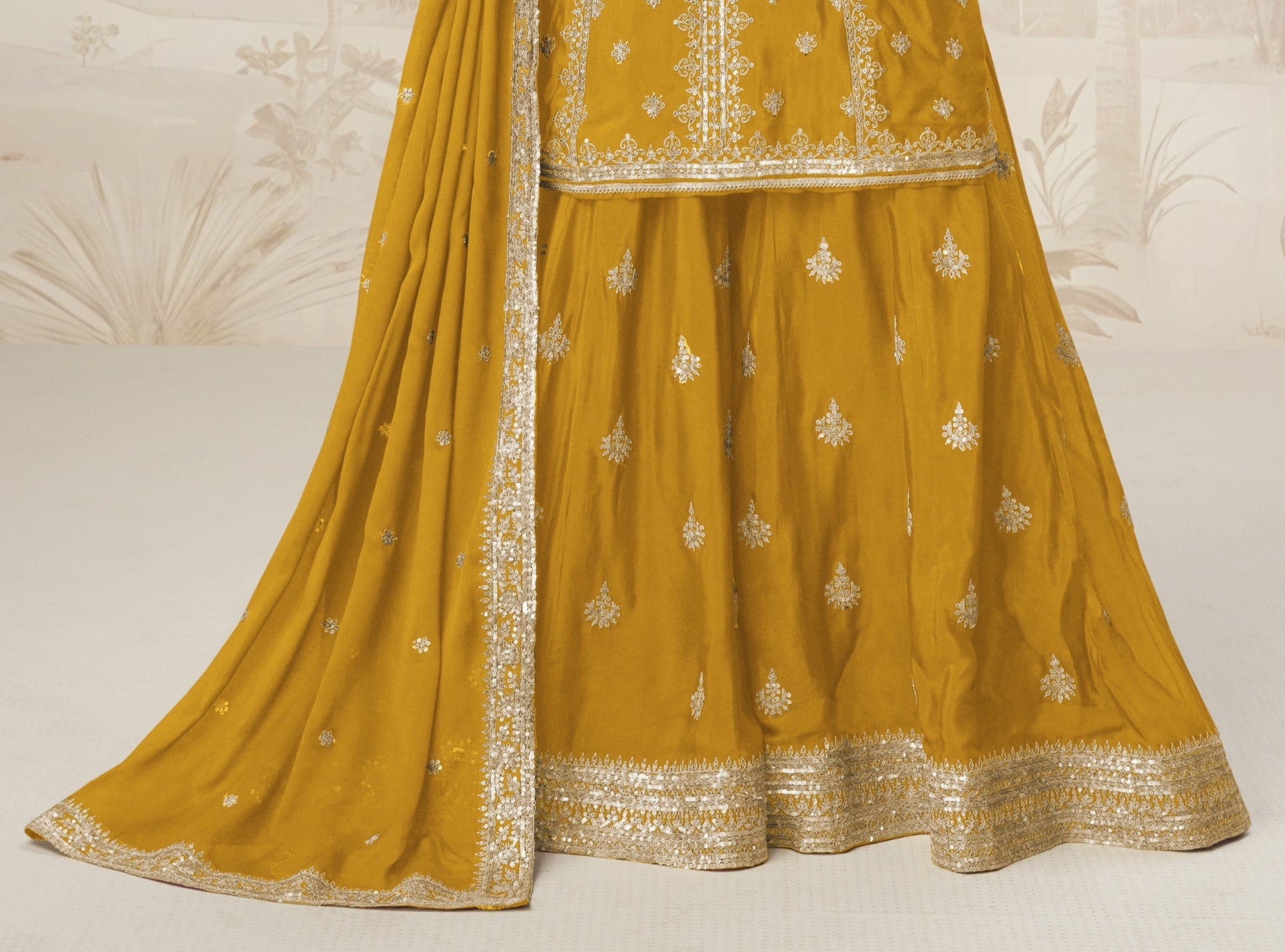 Yellow color palazzo suit with embroidery work, radiating cheerful elegance and festive charm, perfect for traditional occasions and celebrations.
