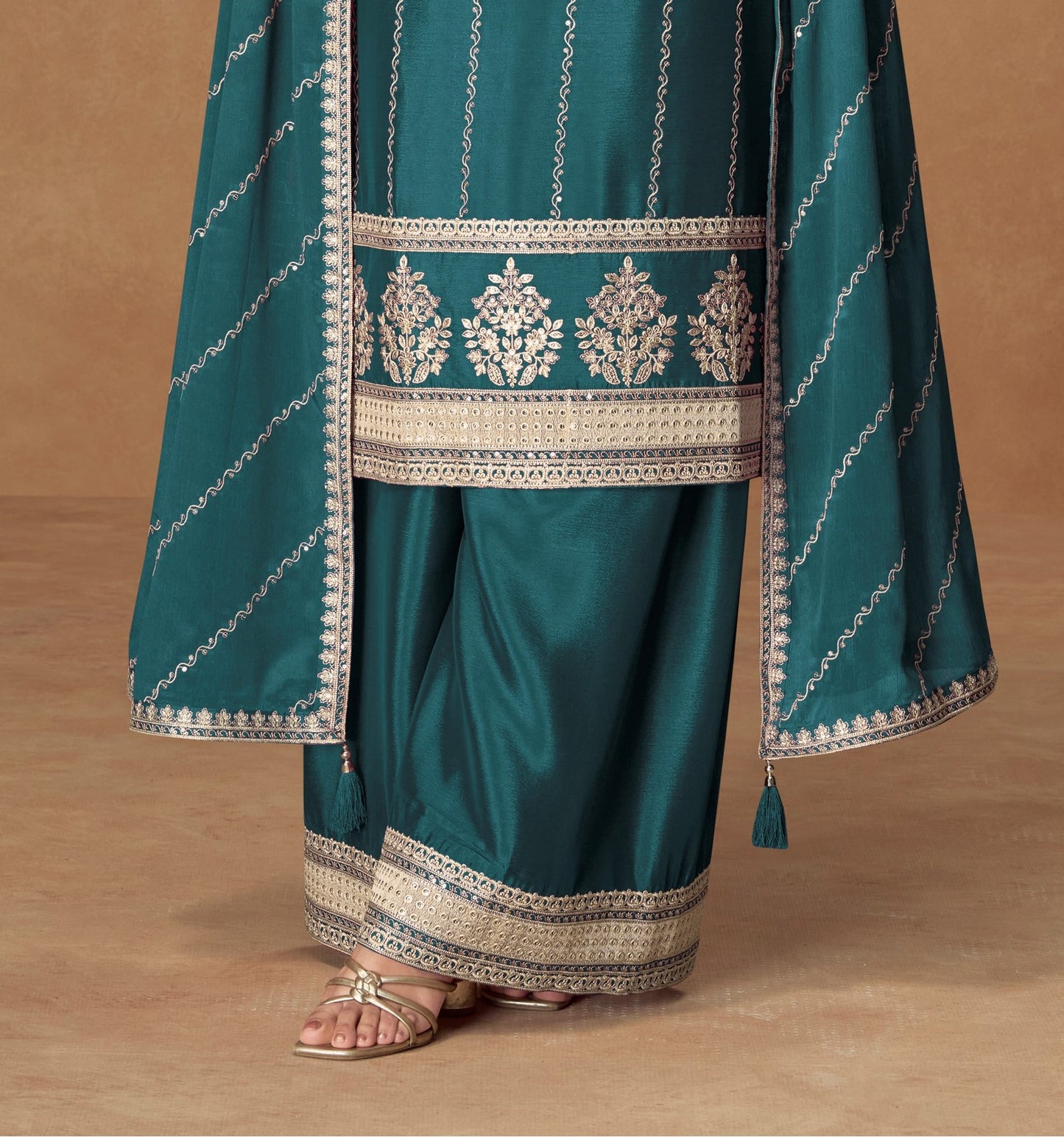 Teal blue color palazzo suit with embroidery work, offering a vibrant and sophisticated look ideal for festive and cultural occasions.
