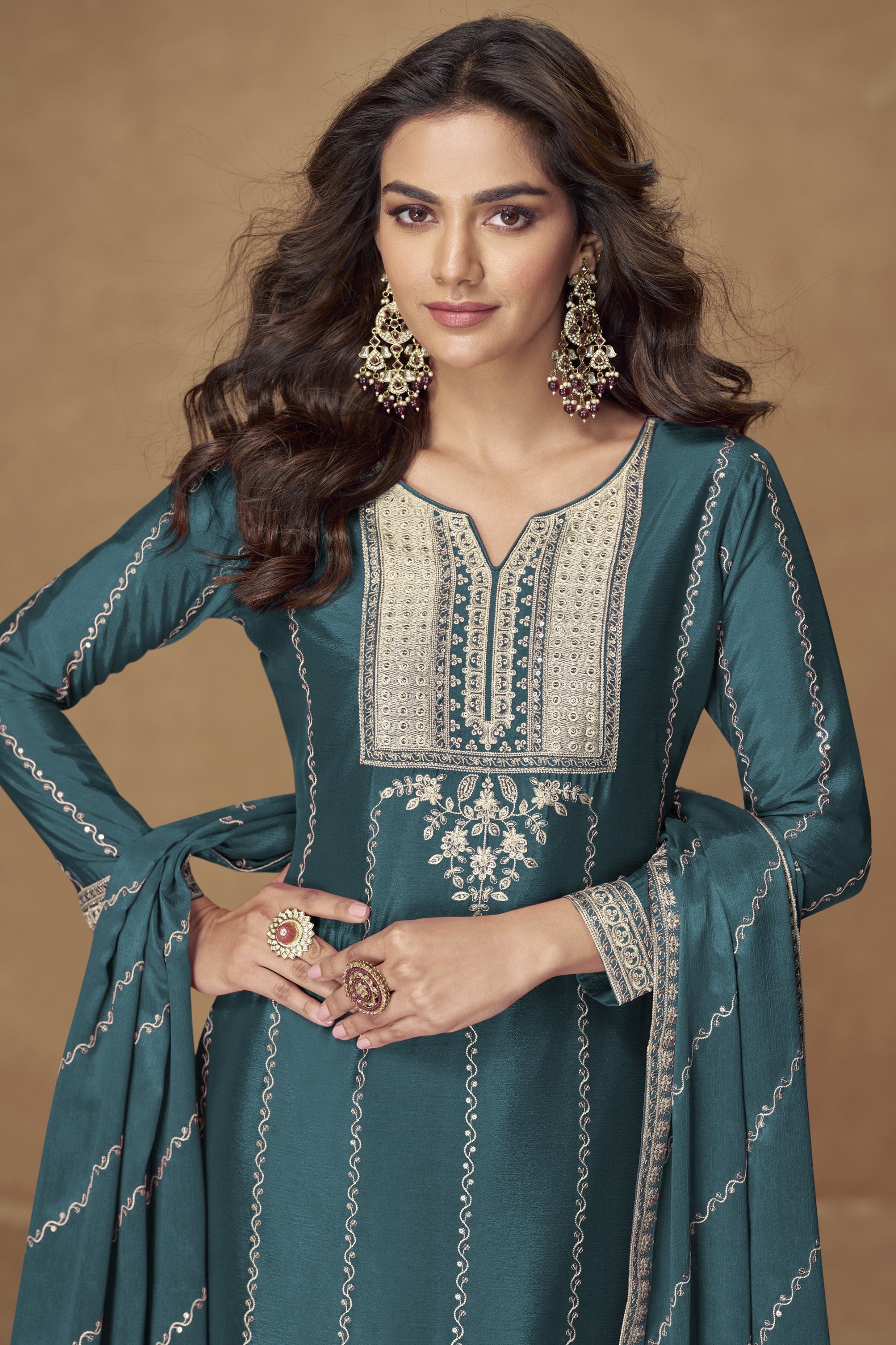 Teal blue color palazzo suit with embroidery work, offering a vibrant and sophisticated look ideal for festive and cultural occasions.
