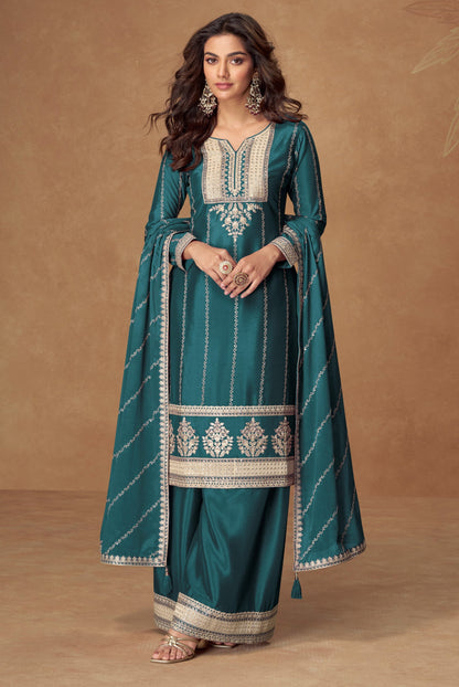 Teal blue color palazzo suit with embroidery work, offering a vibrant and sophisticated look ideal for festive and cultural occasions.
