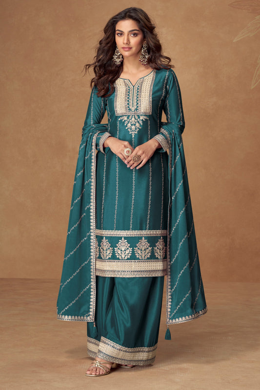 Teal blue color palazzo suit with embroidery work, offering a vibrant and sophisticated look ideal for festive and cultural occasions.
