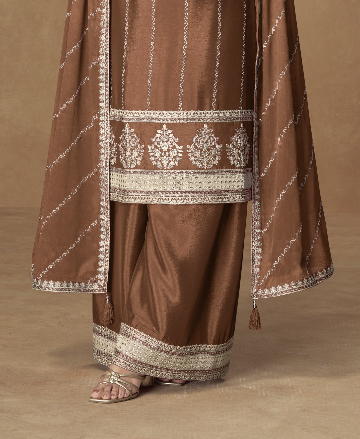 Brown color palazzo suit with embroidery work, featuring warm earthy tones and traditional detailing perfect for festive and formal occasions.
