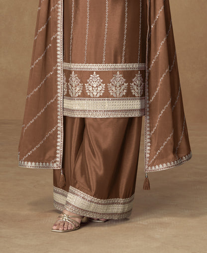 Brown color palazzo suit with embroidery work, featuring warm earthy tones and traditional detailing perfect for festive and formal occasions.

