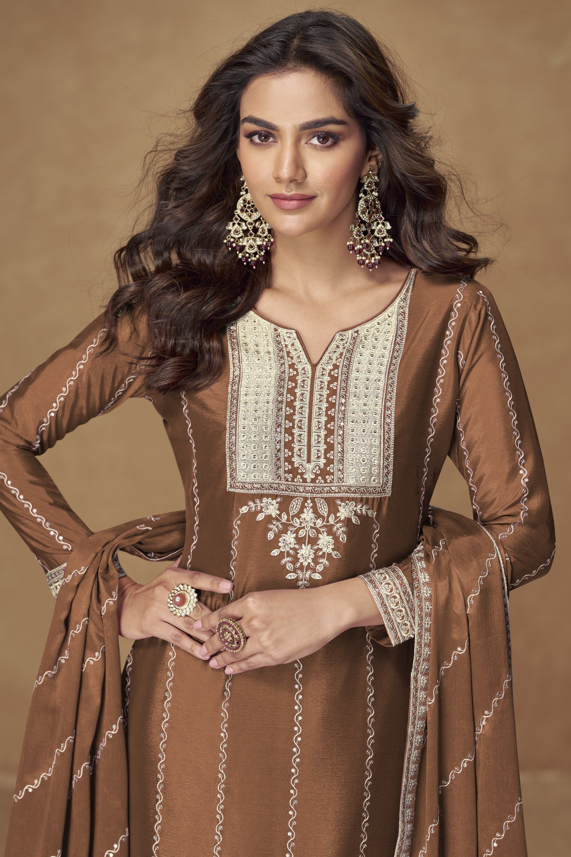 Brown color palazzo suit with embroidery work, featuring warm earthy tones and traditional detailing perfect for festive and formal occasions.
