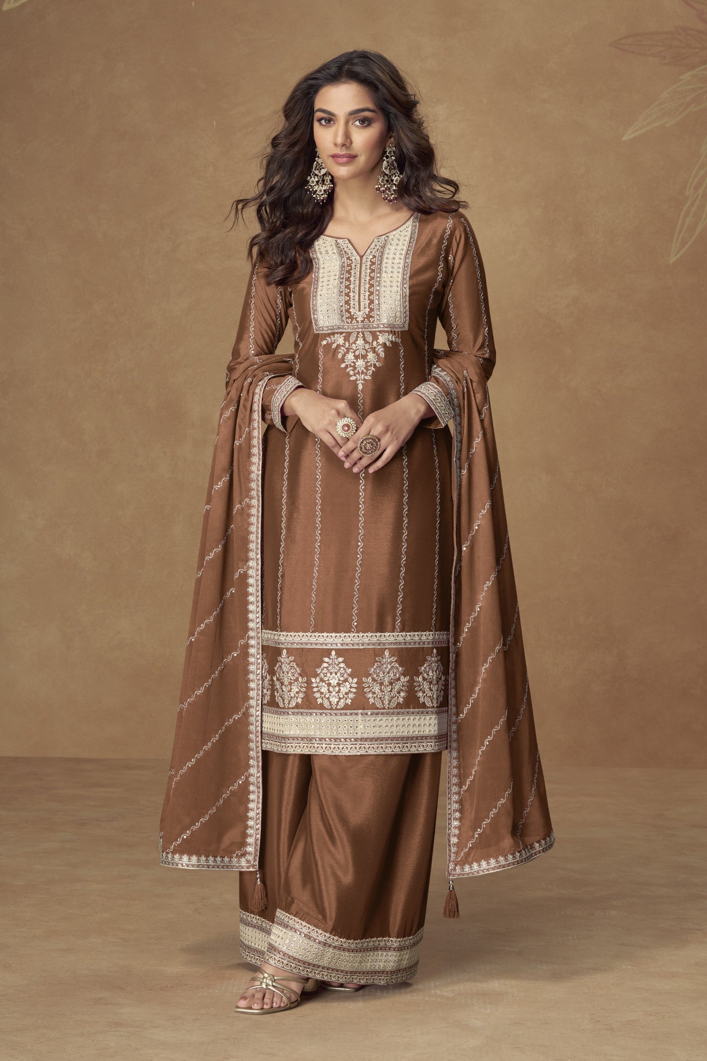 Brown color palazzo suit with embroidery work, featuring warm earthy tones and traditional detailing perfect for festive and formal occasions.
