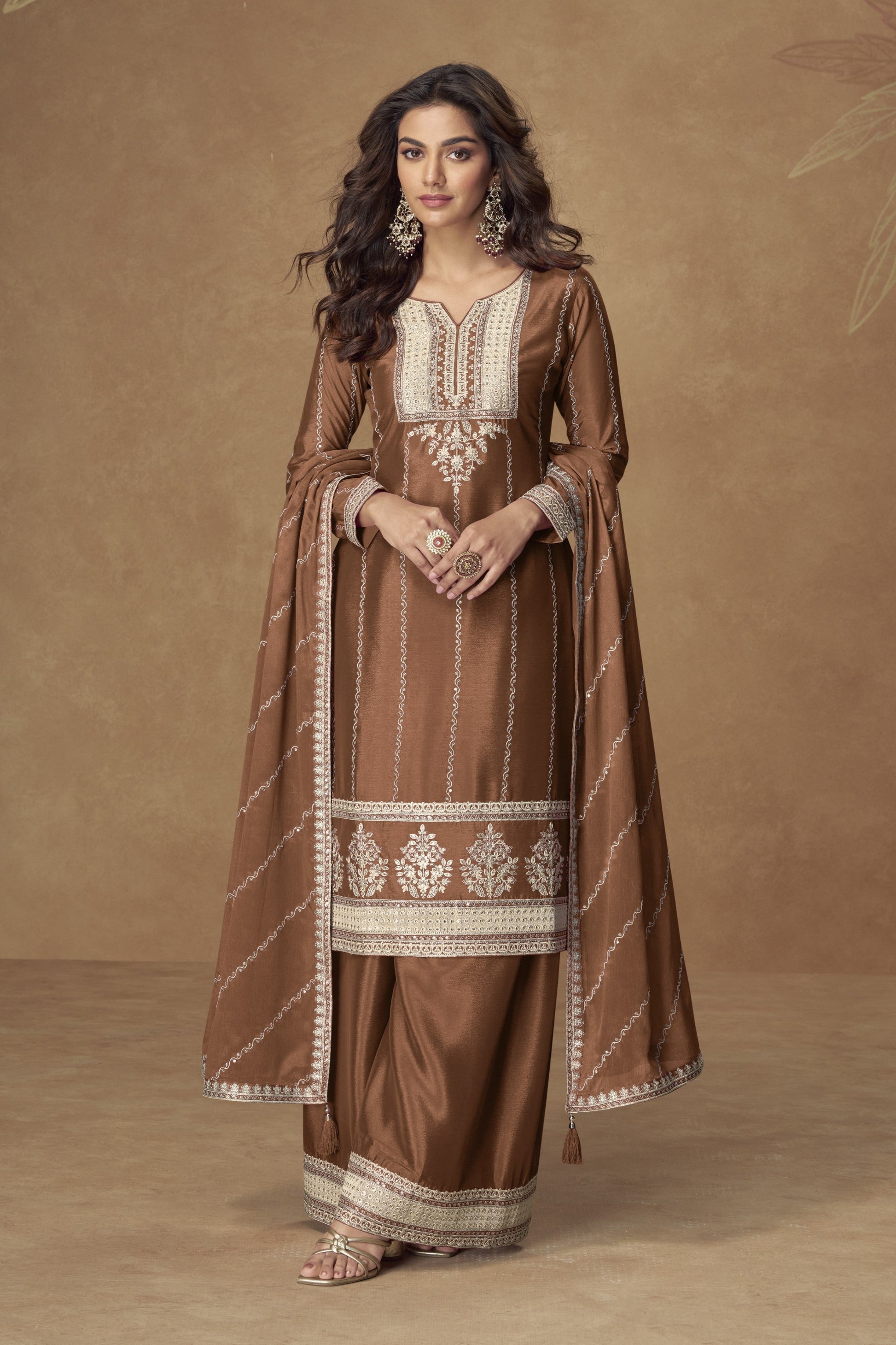 Brown color palazzo suit with embroidery work, featuring warm earthy tones and traditional detailing perfect for festive and formal occasions.
