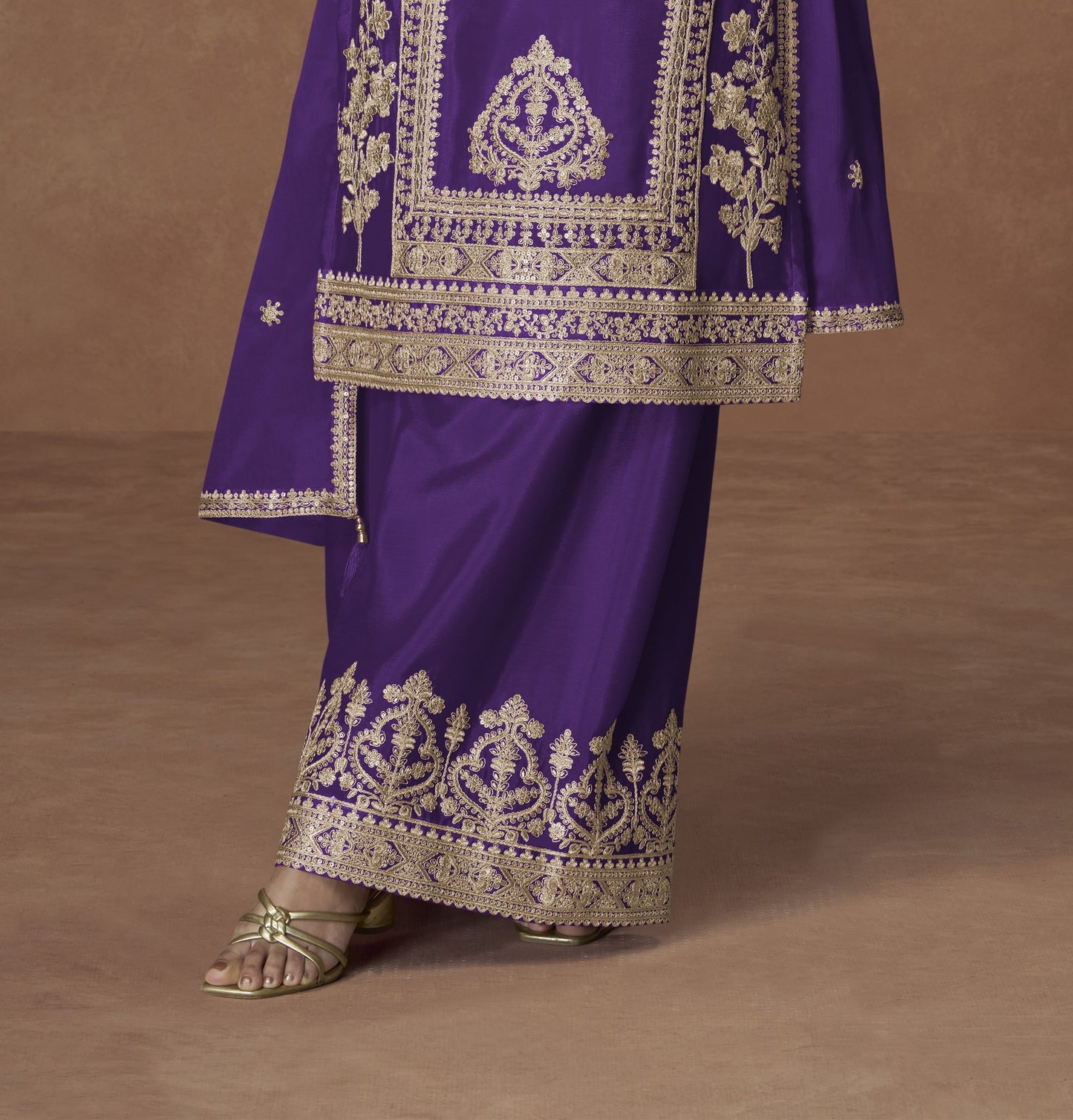 Purple color palazzo suit with embroidery work, offering a regal and graceful look ideal for festive and traditional occasions.
